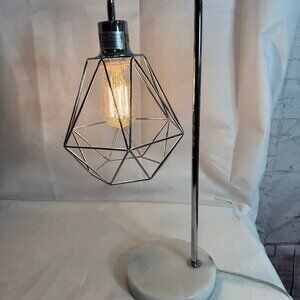 Table Lamp geometric figure featuring a chrome or silver finish wire cage shade